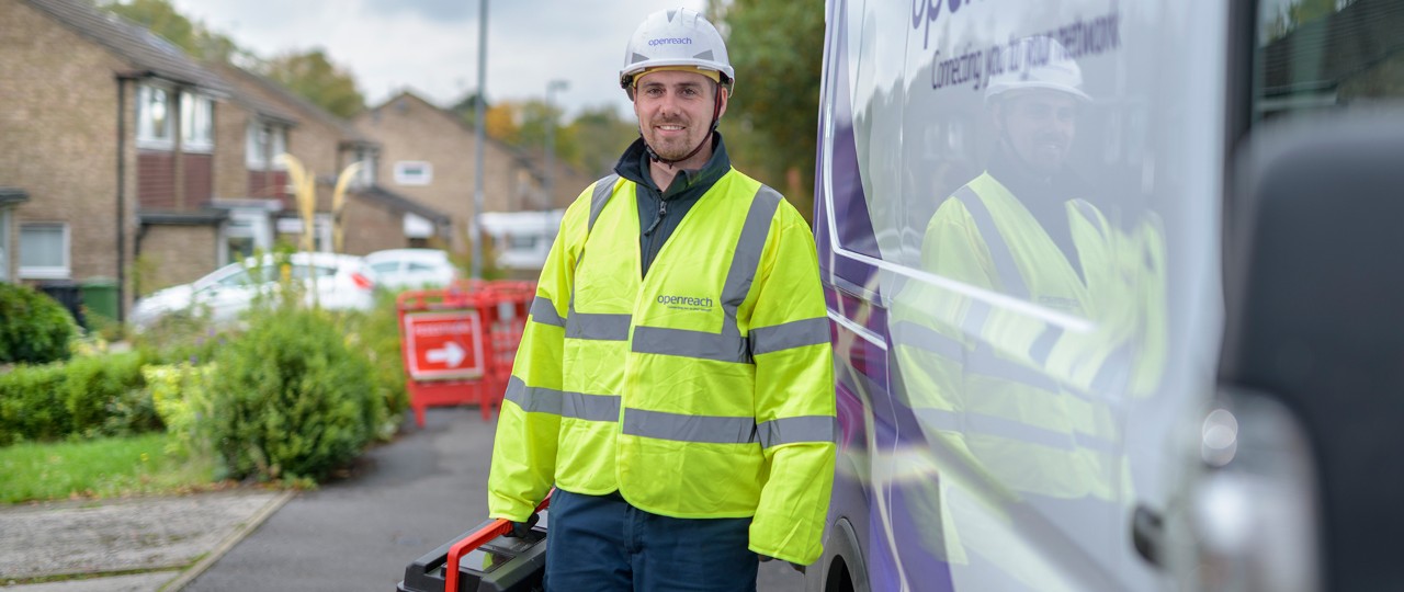 Engineer standing with a smile holding equipment