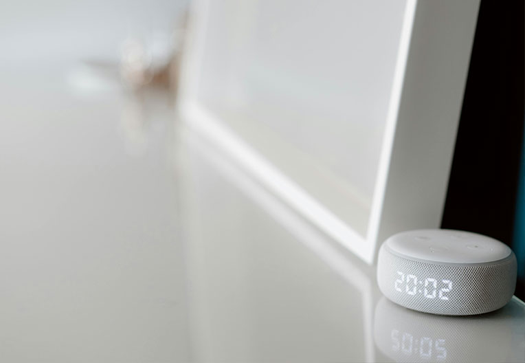 White electronic device with time showing on the table