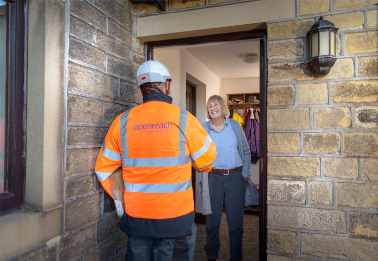 Openreach engineer greeting customer at their doorstep