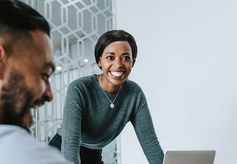 Image of a graduate smiling at work