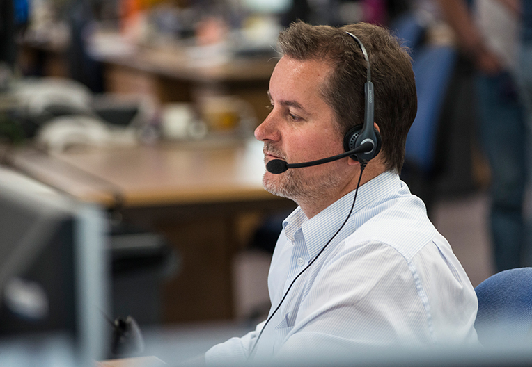 Image of an office worker wearing a headset