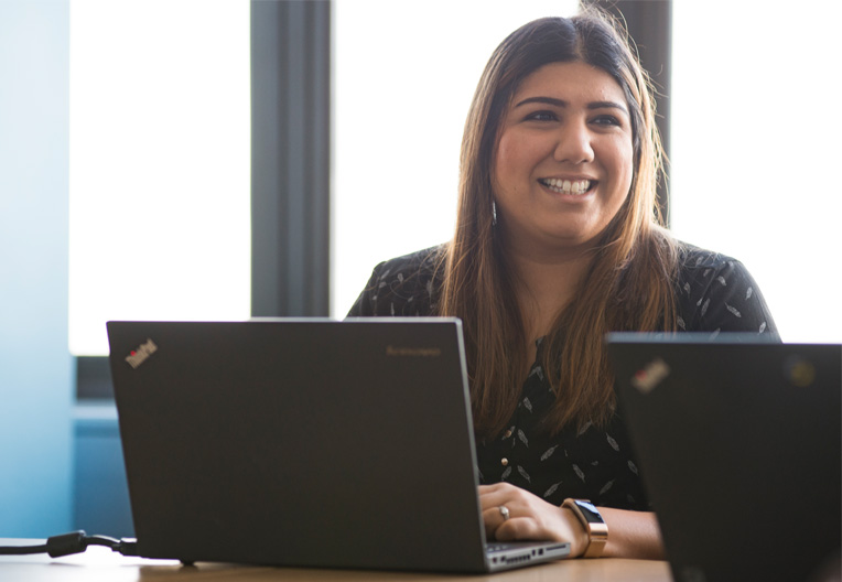 Image of a woman working at her laptop