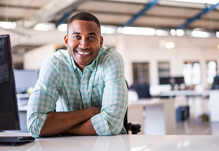 Image of a graduate at his desk