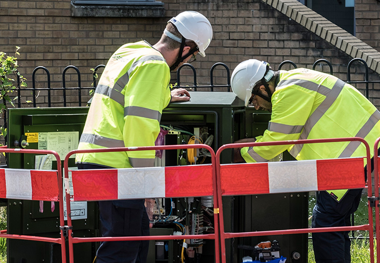 Image of Openreach engineers working on a cabinet.