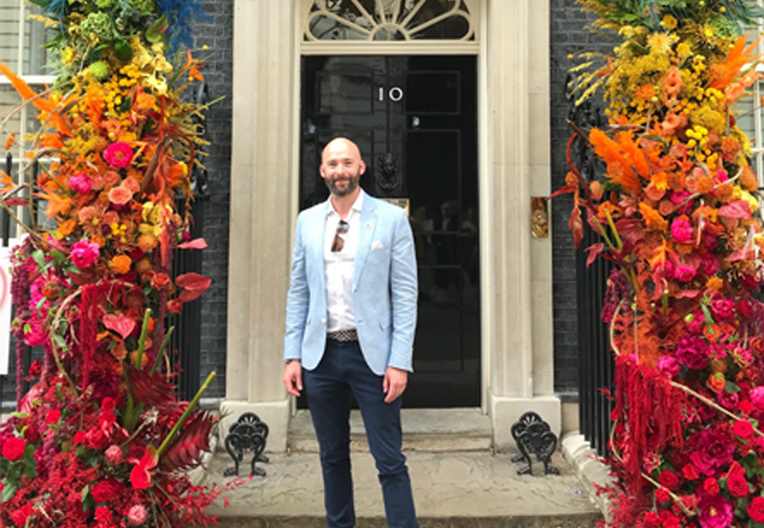 Michael Salter-Church, Openreach Director of External Affairs and Policy in front of the Pride flower display at number 10 Downing Street