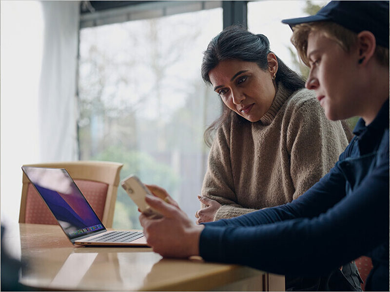 Two business owners discussing Full Fibre broadband options for their business premises