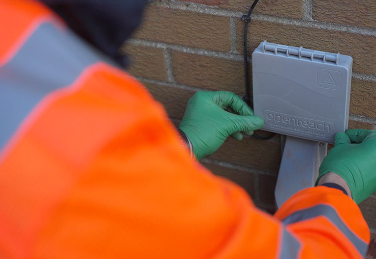Engineer mounting ONT on wall