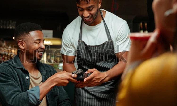 Customer paying for a meal using his phone