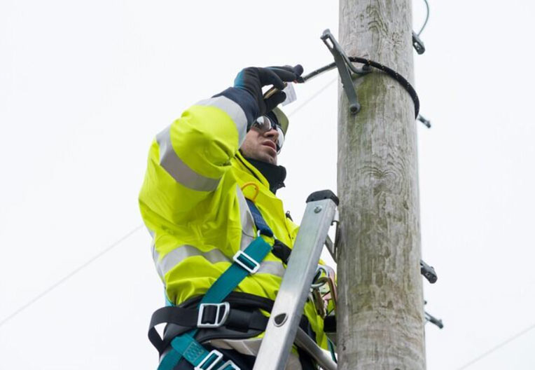 Openreach engineer working on pole