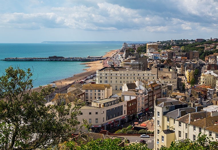 Aerial view of city buildings with the sea in the background during daytime