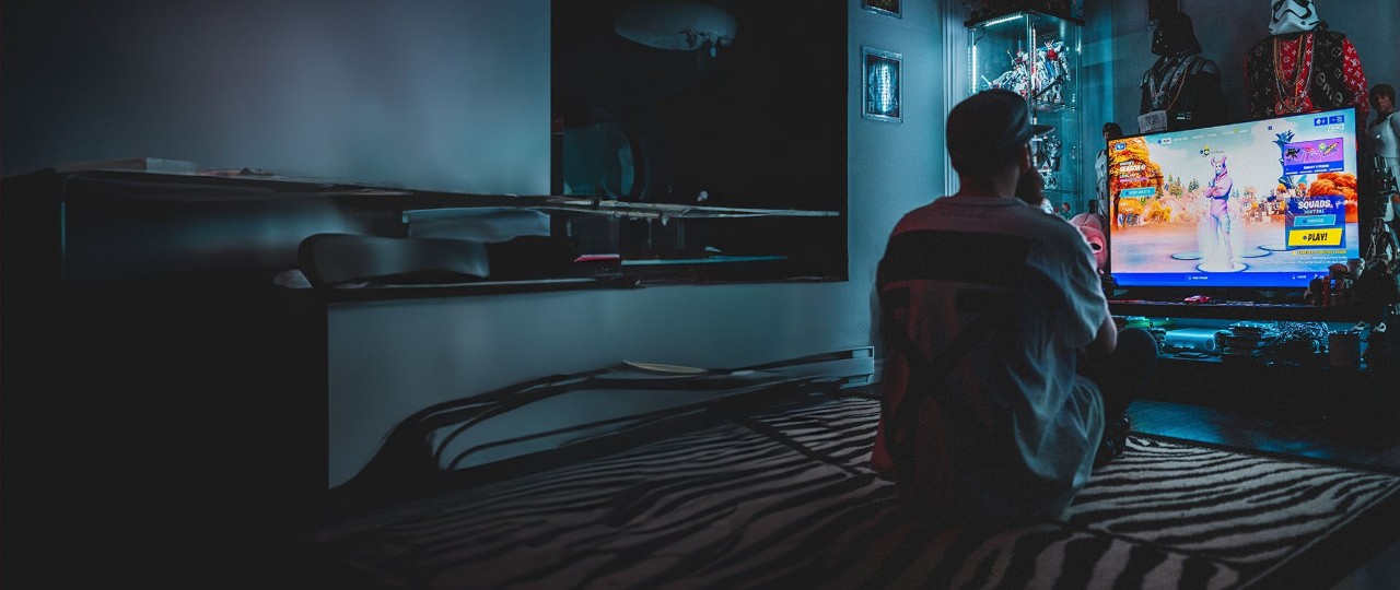 Man playing a game in his bedroom