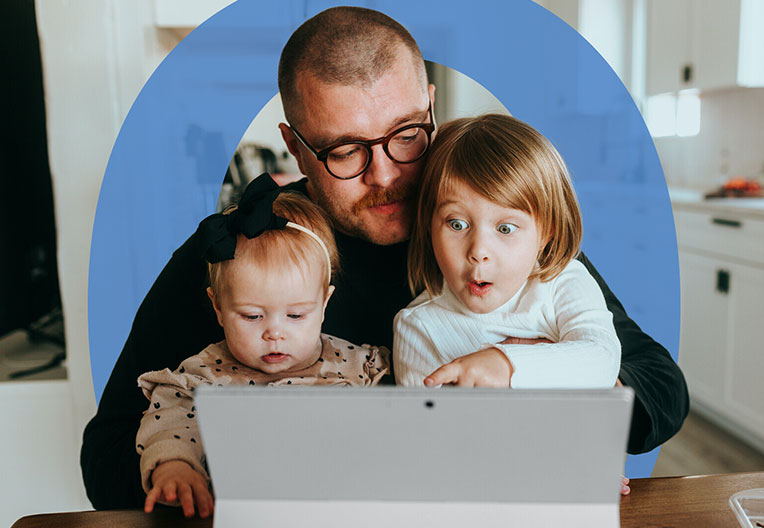 Father and daughters watching laptop