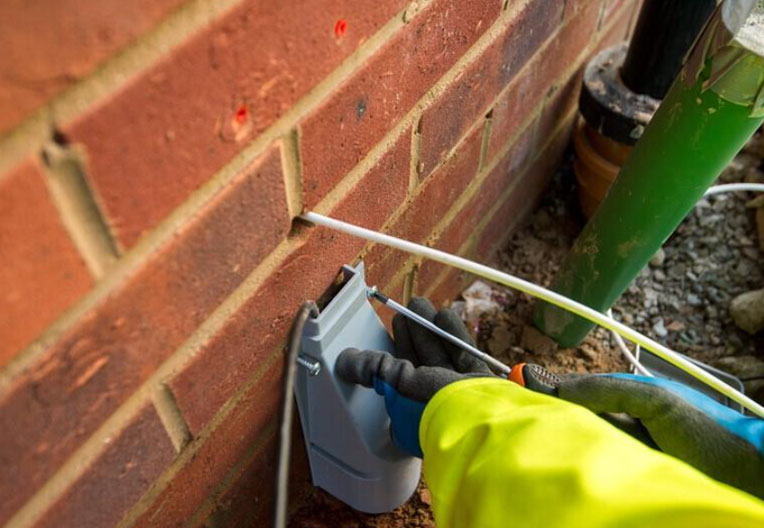Openreach engineer installing outdoor unit