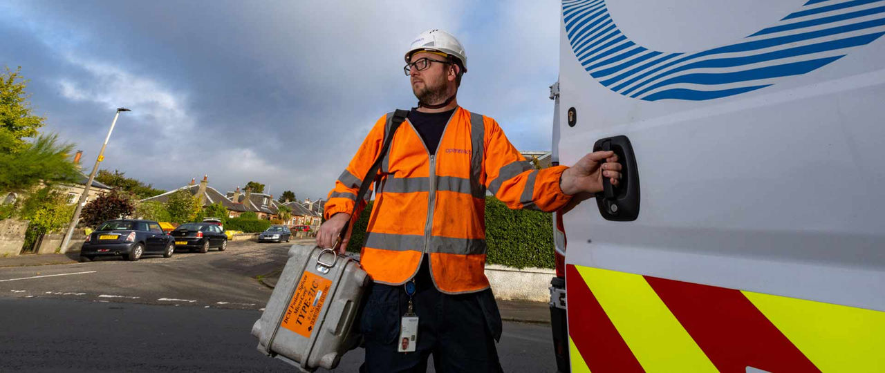 Openreach engineer standing next to branded van in East England community 