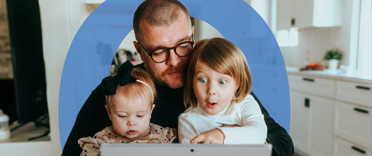 Father and daughters watching laptop