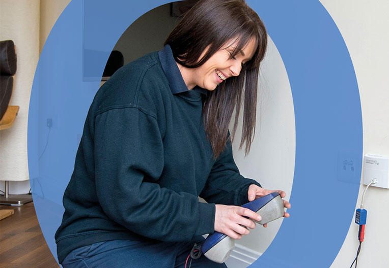 Engineer install an ONT (Optical Network Terminal) inside the property