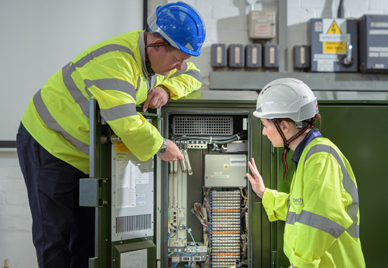 Engineers working on a cabinet