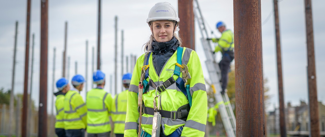 Female engineer facing the camera with other engineers in the background