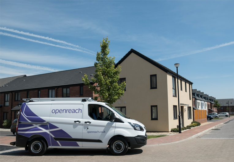 Openreach van parked outside a housing development on a sunny day